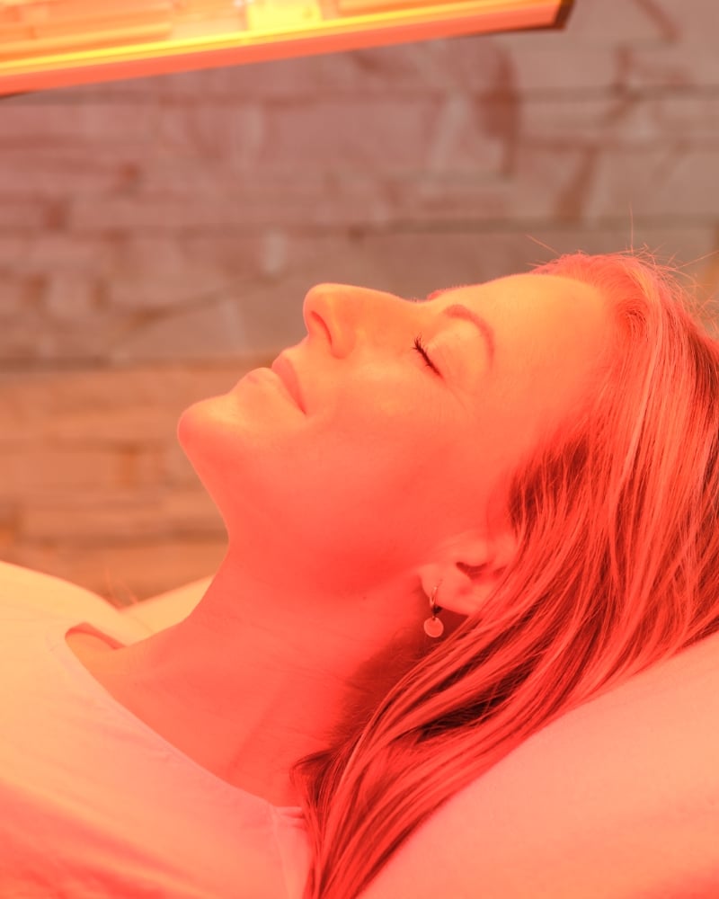 Entspannte Frau während einer Beautylight-Anwendung bei SUNART zur Förderung von Wohlbefinden und Hautpflege.